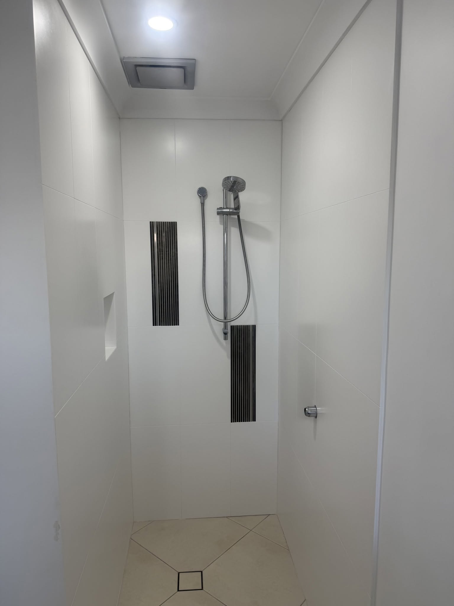 Shower recess refresh: Existing cream surfaces resurfaced in a clean white finish