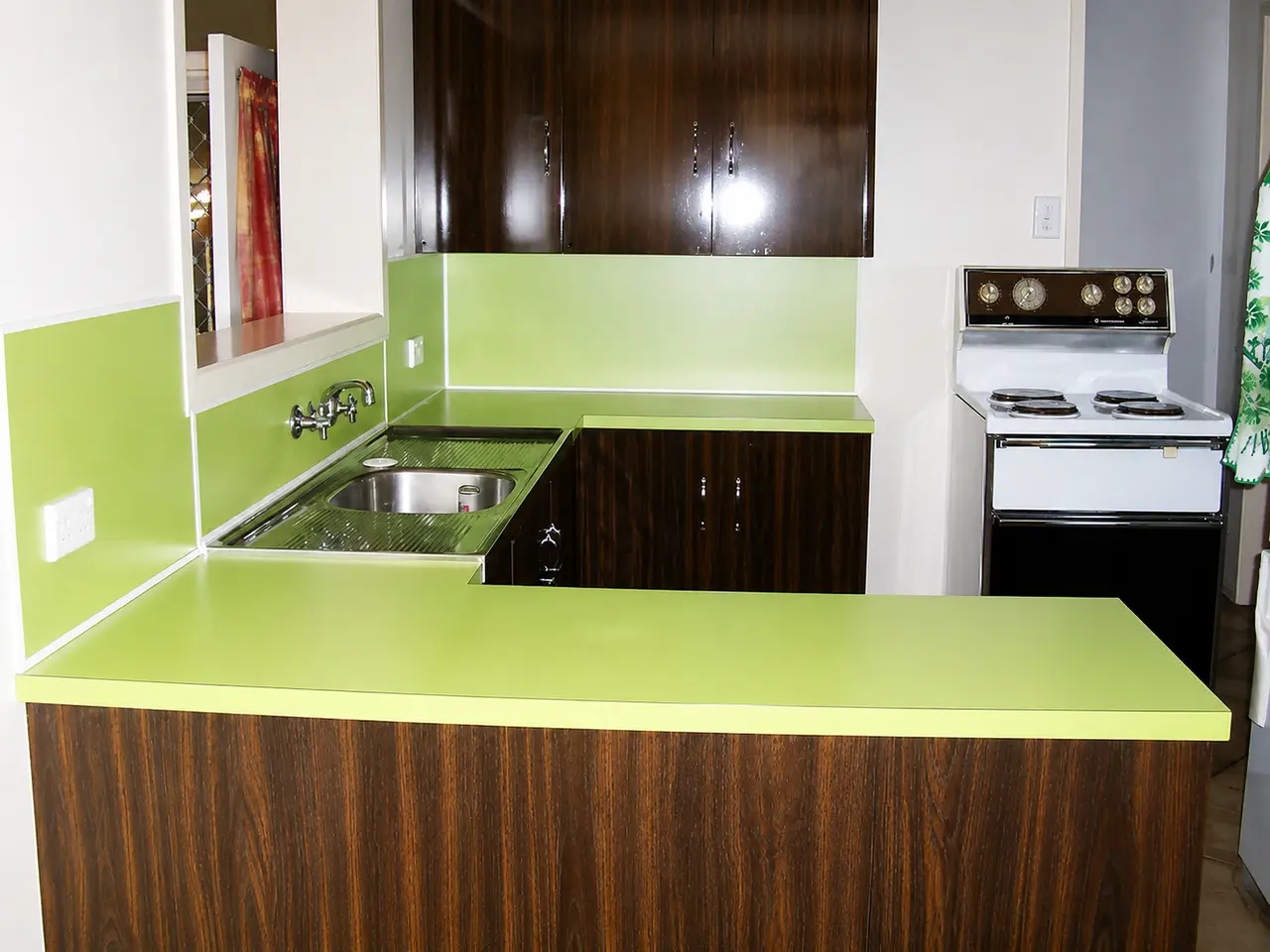 Kitchen before resurfacing with bright lime-green benchtop and splashback